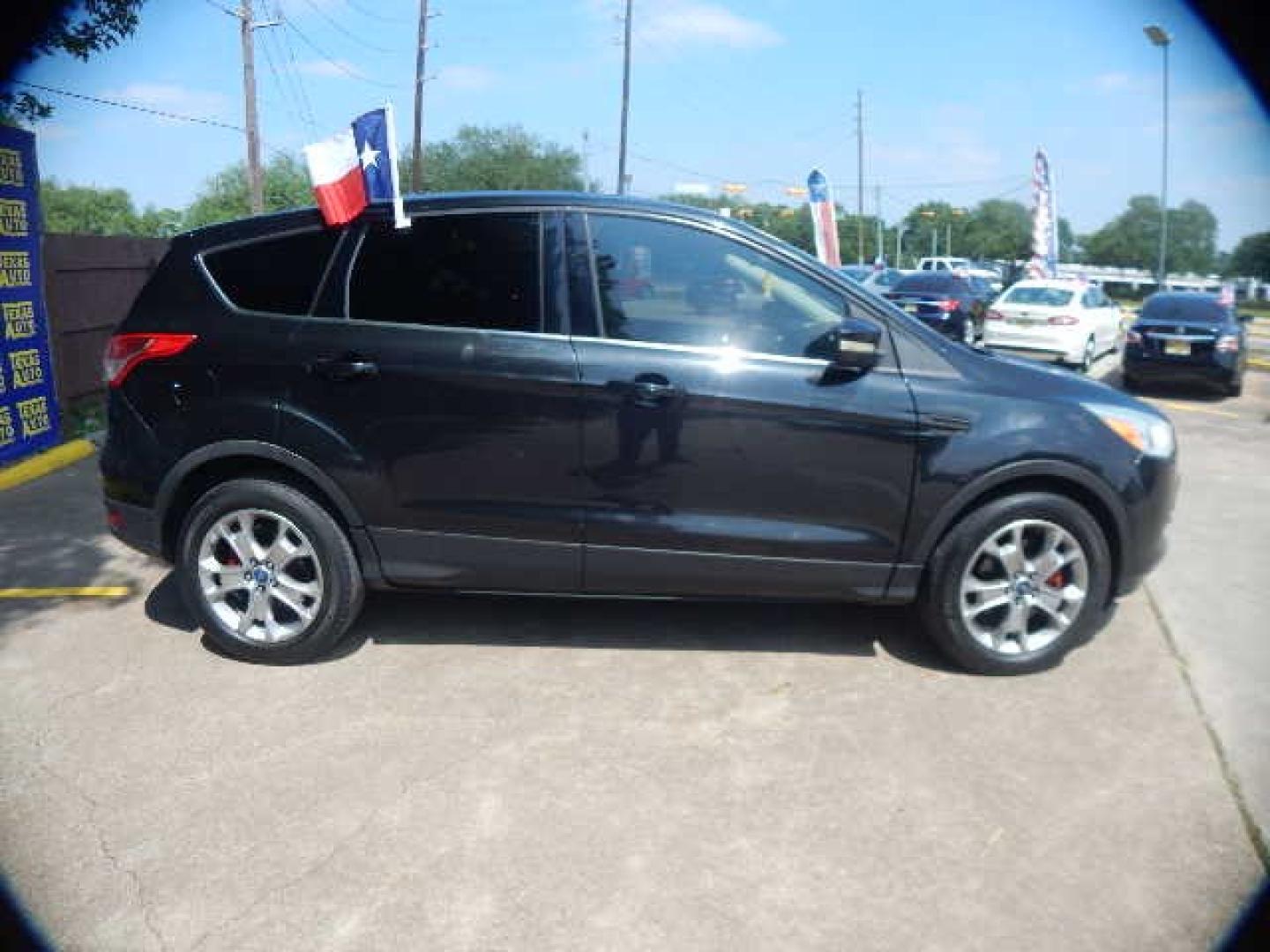 2013 BLACK Ford Escape SEL 4WD (1FMCU9H97DU) with an 2.0L L4 DOHC 16V engine, 6-Speed Automatic transmission, located at 16710 Clay Rd., Houston, TX, 77084, (281) 859-7900, 0.000000, 0.000000 - Low Down. Low Payments. - Photo#4